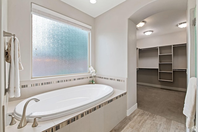 2914 E 1880 S, St George, UT 84790 - full bath featuring a bath, a walk in closet, plenty of natural light, and wood finished floors