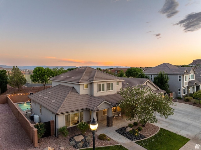 2914 E 1880 S, St George, UT 84790 - view of front facade featuring stucco siding, a tile roof, concrete driveway, a fenced backyard, and a patio