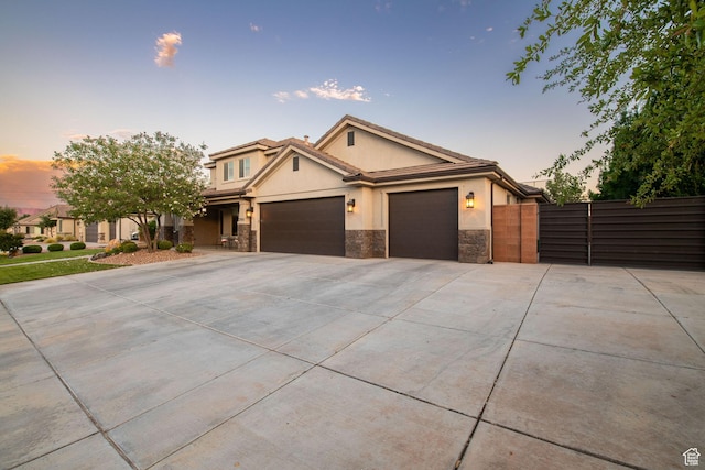2914 E 1880 S, St George, UT 84790 - view of front of home featuring stucco siding, an attached garage, concrete driveway, and stone siding