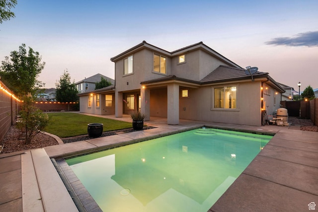 2914 E 1880 S, St George, UT 84790 - back of property at dusk with stucco siding and a patio