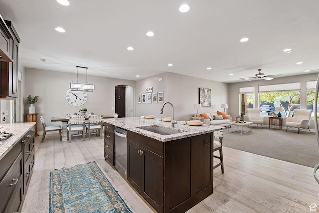 2914 E 1880 S, St George, UT 84790 - kitchen featuring a sink, arched walkways, dishwasher, dark brown cabinets, and recessed lighting