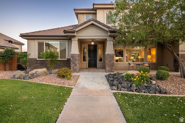 2914 E 1880 S, St George, UT 84790 - view of front of property featuring stone siding, stucco siding, a front lawn, and a tiled roof