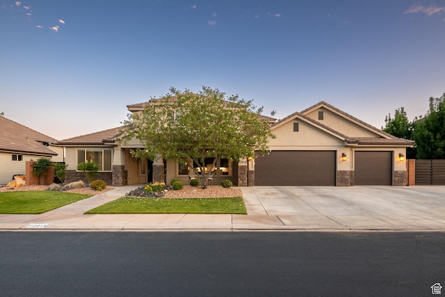 2914 E 1880 S, St George, UT 84790 - view of front of property with stone siding, an attached garage, driveway, stucco siding, and a tile roof