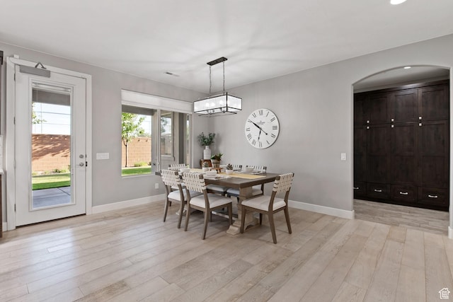 2914 E 1880 S, St George, UT 84790 - dining room featuring arched walkways, light wood-style flooring, baseboards, and a chandelier