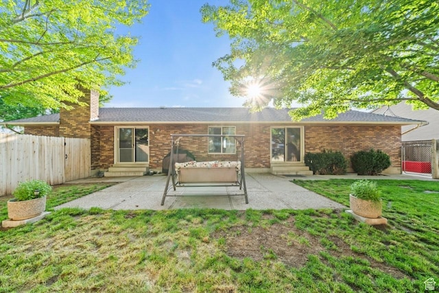 2045 W 5025 S, Roy, UT 84067 - rear view of property featuring entry steps, a patio, a chimney, and brick siding