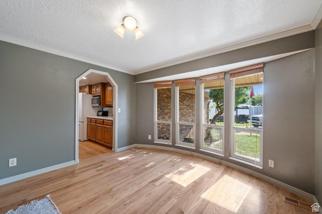 2045 W 5025 S, Roy, UT 84067 - unfurnished room featuring light wood-style floors, ornamental molding, a textured ceiling, and arched walkways