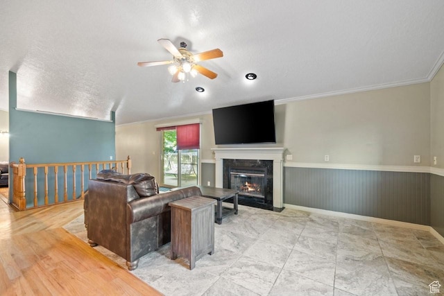 2045 W 5025 S, Roy, UT 84067 - living room featuring ceiling fan, a wainscoted wall, a textured ceiling, crown molding, and a premium fireplace