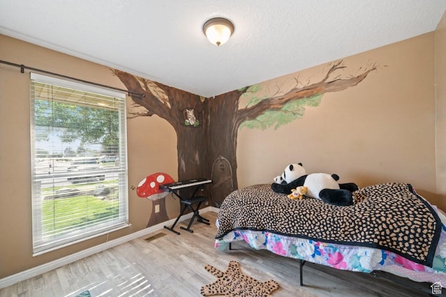 2045 W 5025 S, Roy, UT 84067 - bedroom with multiple windows and wood finished floors
