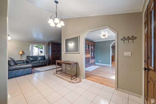 2045 W 5025 S, Roy, UT 84067 - living room featuring light tile patterned floors, arched walkways, ornamental molding, vaulted ceiling, and a chandelier