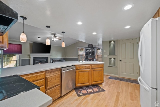 2045 W 5025 S, Roy, UT 84067 - kitchen with freestanding refrigerator, dishwasher, light wood-style floors, a warm lit fireplace, and open floor plan
