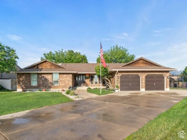 2045 W 5025 S, Roy, UT 84067 - single story home with concrete driveway, a garage, a front lawn, and brick siding