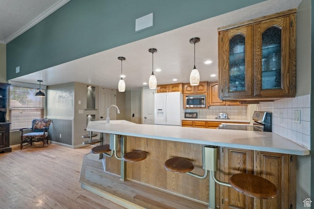2045 W 5025 S, Roy, UT 84067 - kitchen featuring stainless steel microwave, white fridge with ice dispenser, stove, ornamental molding, and light countertops