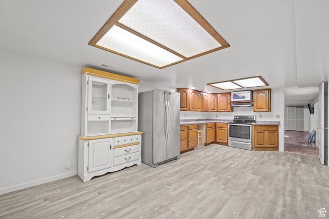 2045 W 5025 S, Roy, UT 84067 - kitchen featuring appliances with stainless steel finishes, light wood-style floors, brown cabinets, and light countertops