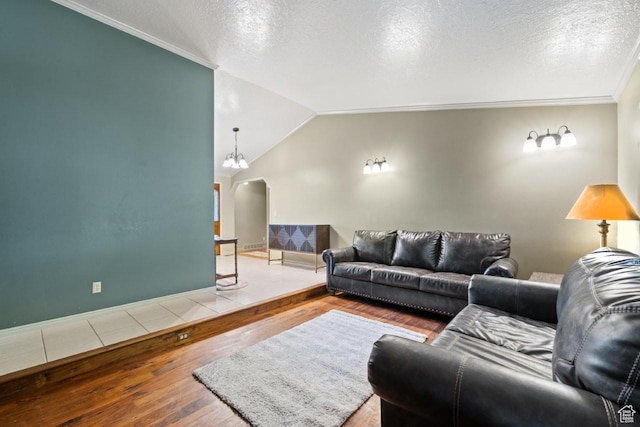 2045 W 5025 S, Roy, UT 84067 - living area with arched walkways, wood-type flooring, lofted ceiling, and a textured ceiling