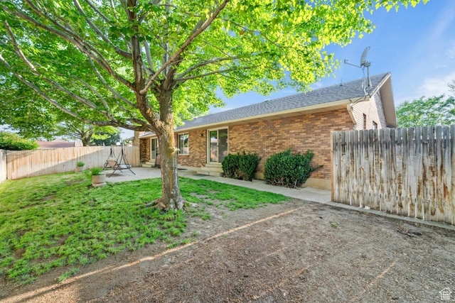 2045 W 5025 S, Roy, UT 84067 - rear view of property featuring brick siding, entry steps, a patio, and a shingled roof
