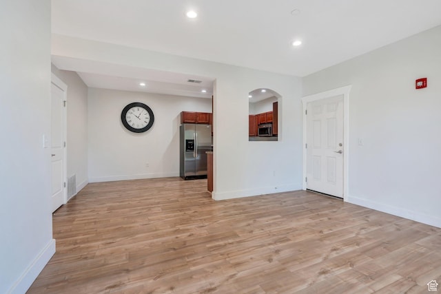 143 W Spring Hill Way N, Saratoga Springs, UT 84045 - unfurnished living room featuring recessed lighting, light wood-style flooring, baseboards, and arched walkways