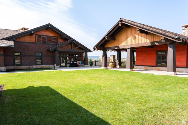9747 N Ridgeway Cir Unit Rw-21, Kamas, UT 84036 - rear view of house featuring a chimney, a lawn, and a patio