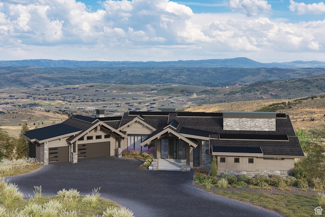 9747 N Ridgeway Cir Unit Rw-21, Kamas, UT 84036 - view of front facade featuring stone siding, an attached garage, a mountain view, and driveway