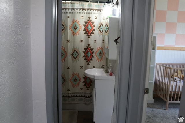 484 N Main St, Malad City, ID 83252 - full bathroom featuring vanity, a textured wall, and a shower with shower curtain