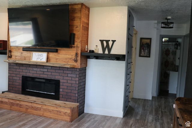 484 N Main St, Malad City, ID 83252 - living area featuring a fireplace, wood finished floors, and a textured ceiling