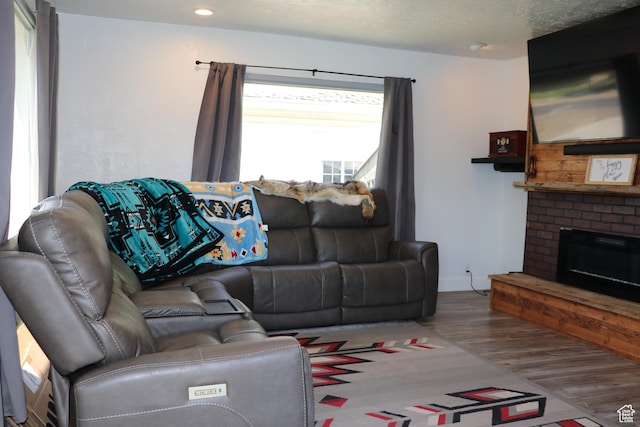 484 N Main St, Malad City, ID 83252 - living area with wood finished floors, a brick fireplace, and recessed lighting