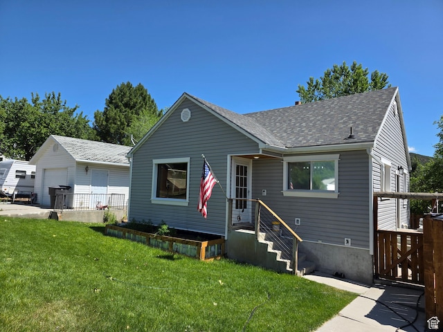 484 N Main St, Malad City, ID 83252 - bungalow featuring a shingled roof, a garage, and an outdoor structure