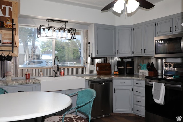 484 N Main St, Malad City, ID 83252 - kitchen featuring dishwashing machine, black range with electric cooktop, stainless steel microwave, a ceiling fan, and light countertops