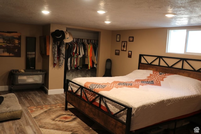 484 N Main St, Malad City, ID 83252 - bedroom with wood finished floors, recessed lighting, a closet, and a textured ceiling