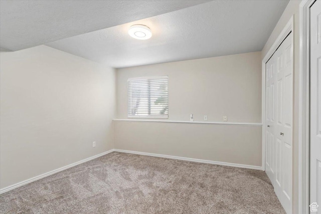 1403 Gleneagles Dr, Syracuse, UT 84075 - unfurnished bedroom with carpet floors, a closet, baseboards, and a textured ceiling