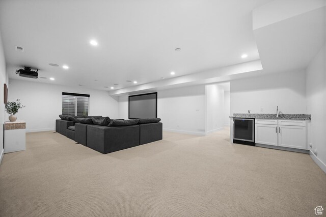 4771 W Juniper Bend Cir, Herriman, UT 84096 - living area with bar with sink, recessed lighting, light colored carpet, baseboards, and wine cooler