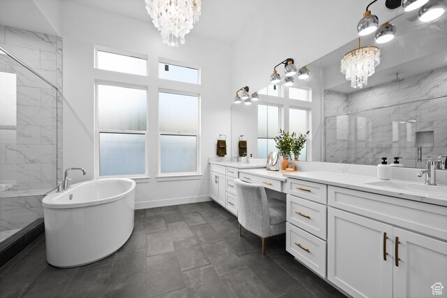 4771 W Juniper Bend Cir, Herriman, UT 84096 - bathroom with a chandelier, a freestanding tub, vanity, a marble finish shower, and baseboards