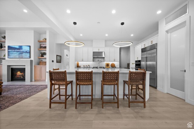 4771 W Juniper Bend Cir, Herriman, UT 84096 - kitchen featuring stainless steel appliances, white cabinets, light wood finished floors, light countertops, and recessed lighting