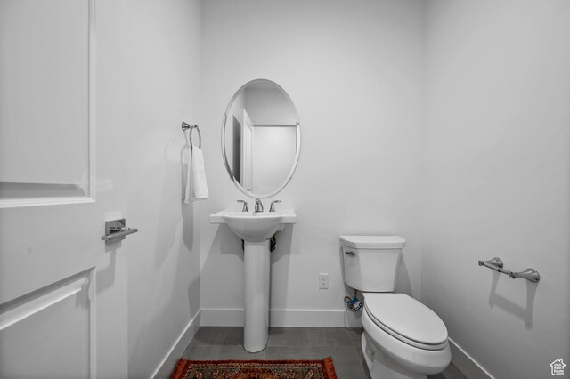 4771 W Juniper Bend Cir, Herriman, UT 84096 - bathroom featuring toilet, baseboards, tile patterned floors, and a sink