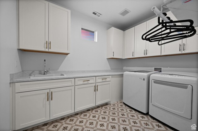 4771 W Juniper Bend Cir, Herriman, UT 84096 - laundry room featuring washer and clothes dryer, cabinet space, and light floors