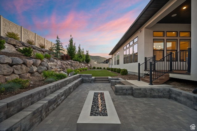 4771 W Juniper Bend Cir, Herriman, UT 84096 - patio terrace at dusk with an outdoor fire pit and a patio