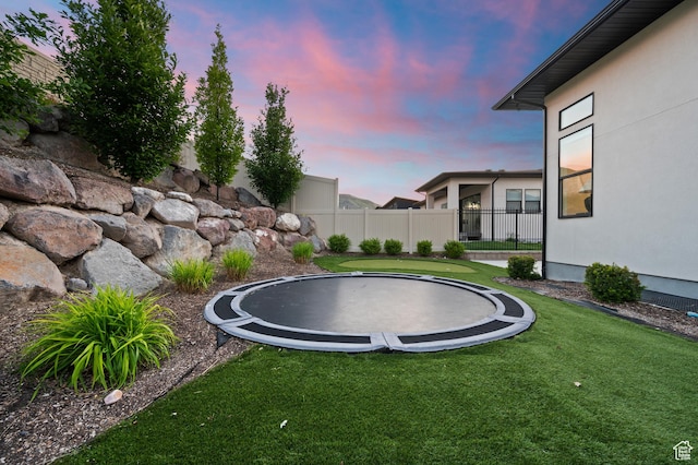 4771 W Juniper Bend Cir, Herriman, UT 84096 - yard at dusk with a trampoline