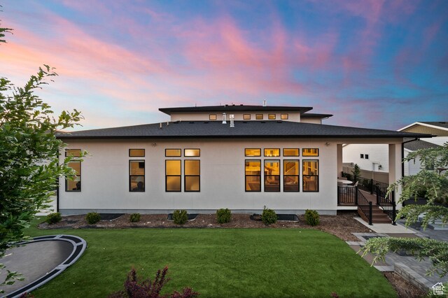 4771 W Juniper Bend Cir, Herriman, UT 84096 - back of house at dusk with a yard and a shingled roof
