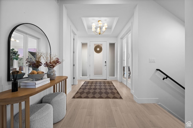 4771 W Juniper Bend Cir, Herriman, UT 84096 - entrance foyer featuring a chandelier, light wood-type flooring, baseboards, and a raised ceiling