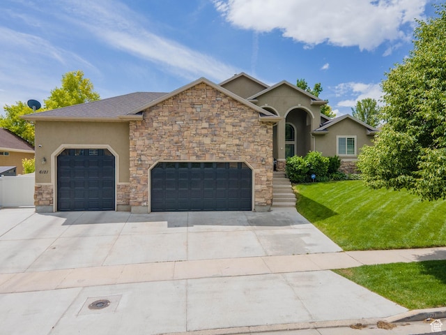 6121 W Indian Oak Dr S, West Jordan, UT 84081 - view of front facade with stucco siding, a front lawn, concrete driveway, and a garage