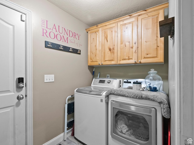 6121 W Indian Oak Dr S, West Jordan, UT 84081 - laundry room featuring cabinet space, washing machine and clothes dryer, a textured ceiling, and wood finished floors