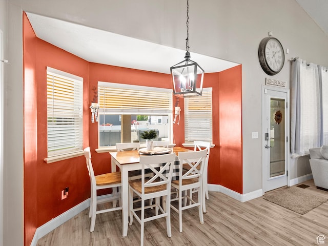 6121 W Indian Oak Dr S, West Jordan, UT 84081 - dining area featuring a chandelier, wood finished floors, and baseboards