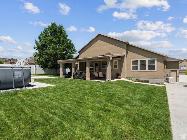 6121 W Indian Oak Dr S, West Jordan, UT 84081 - rear view of property featuring stucco siding and a patio