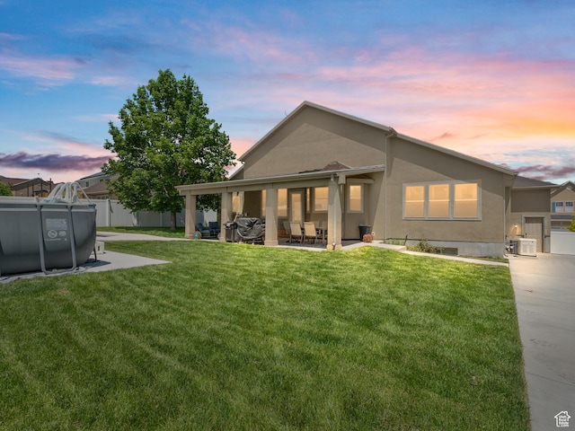 6121 W Indian Oak Dr S, West Jordan, UT 84081 - rear view of property featuring a patio and stucco siding