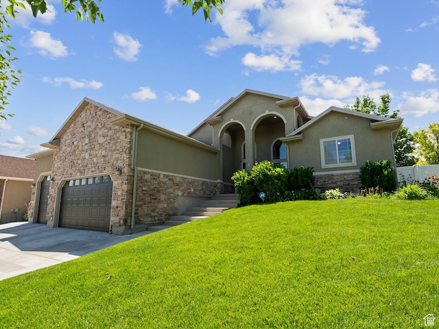 6121 W Indian Oak Dr S, West Jordan, UT 84081 - mediterranean / spanish home featuring stone siding, stucco siding, concrete driveway, and a front lawn