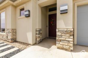 3454 W 150th St N, Hurricane, UT 84737 - view of exterior entry with stone siding and stucco siding