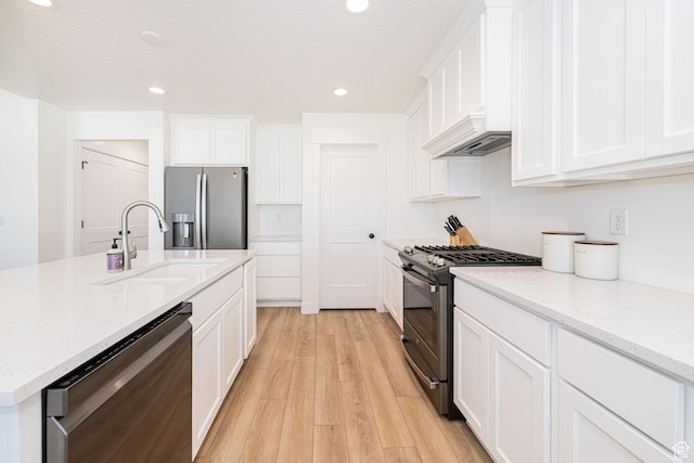 5258 W 3750 S, Hooper, UT 84315 - kitchen featuring appliances with stainless steel finishes, a sink, light wood finished floors, white cabinets, and recessed lighting