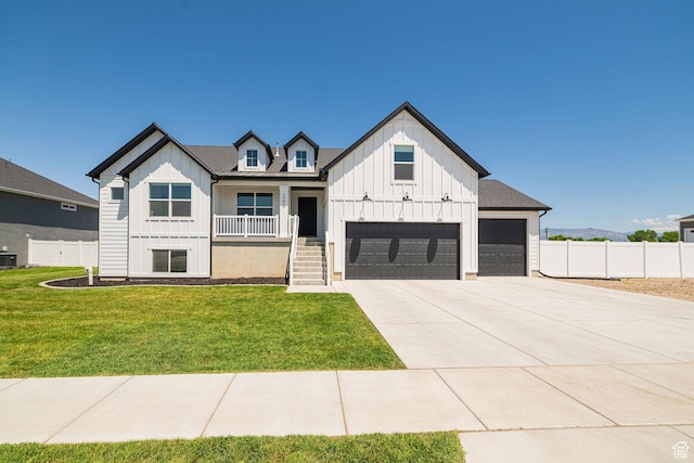 5258 W 3750 S, Hooper, UT 84315 - modern farmhouse style home featuring board and batten siding, a porch, concrete driveway, and a garage