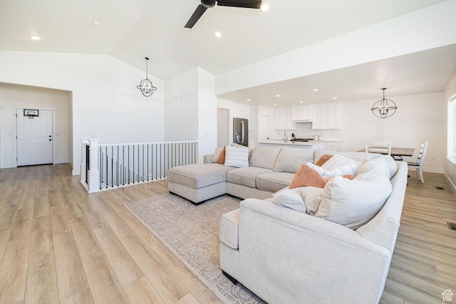 5258 W 3750 S, Hooper, UT 84315 - living room with lofted ceiling, light wood-style floors, a chandelier, ceiling fan, and recessed lighting