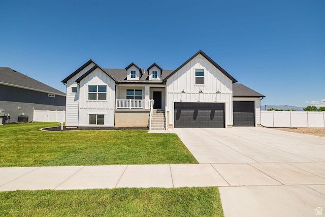 5258 W 3750 S, Hooper, UT 84315 - modern farmhouse style home with board and batten siding, a porch, concrete driveway, and central AC unit
