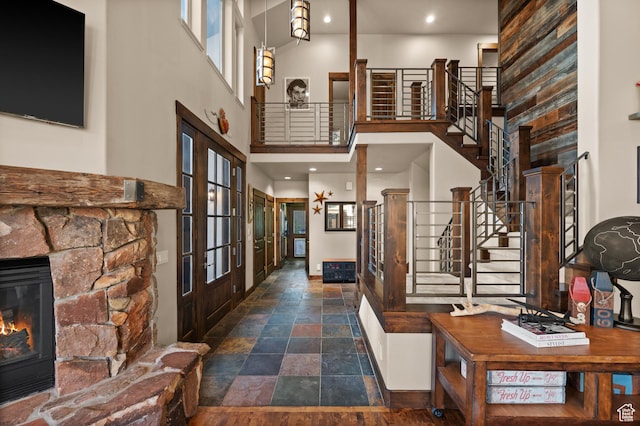 8932 Flint Way, Park City, UT 84098 - entryway with stairway, a high ceiling, stone finish floors, french doors, and a stone fireplace